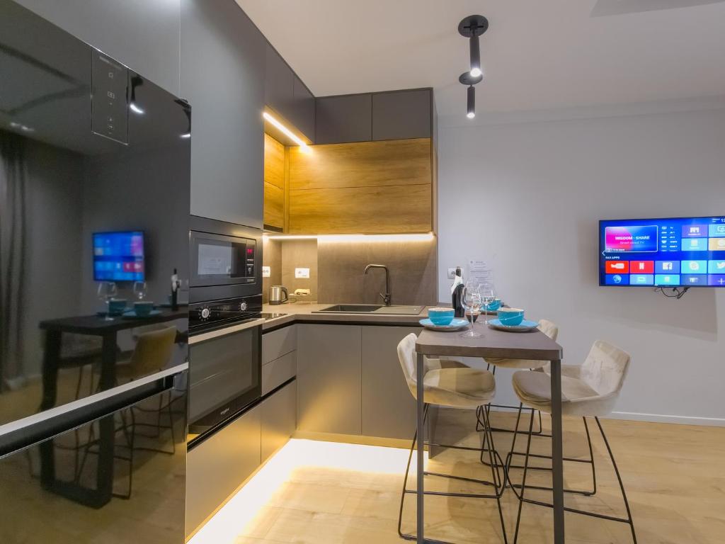 a kitchen with a table and some chairs in it at PIN Apartments in Tirana