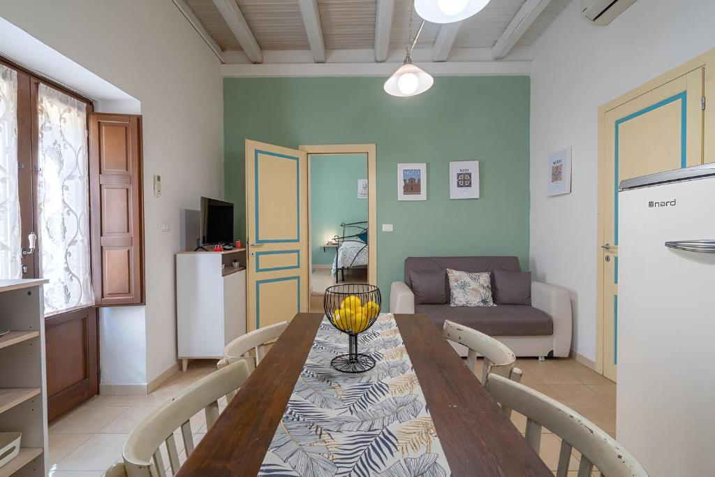a living room with a table and a couch at Noto Barocca - HolidayHome in Noto