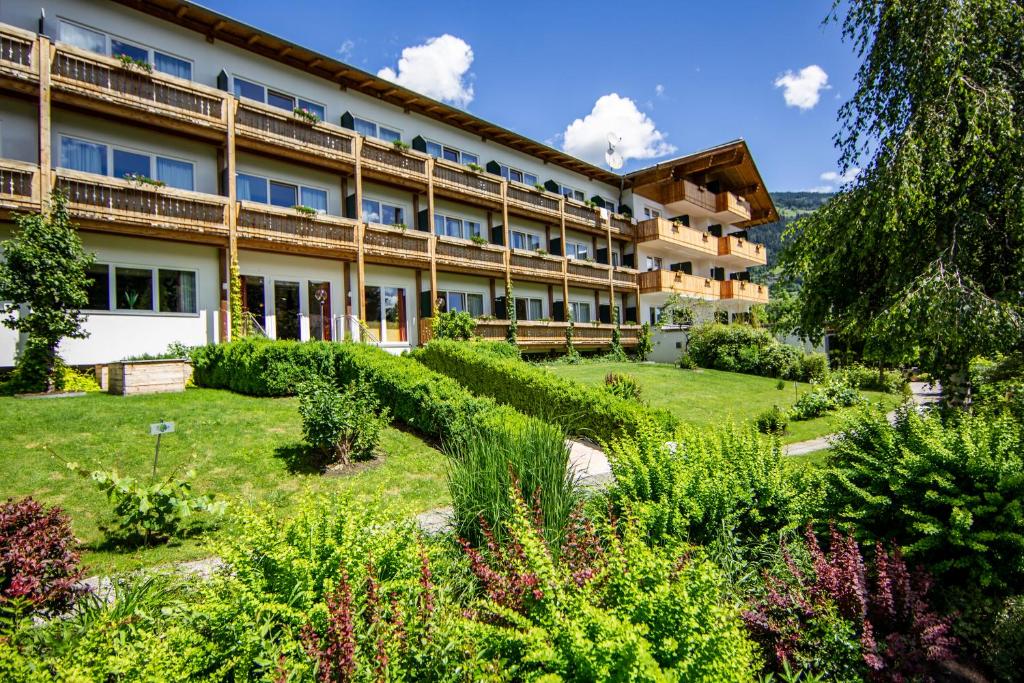 a hotel with a garden in front of it at Hotel Moarhof in Lienz