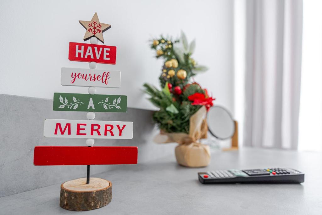 a desk with a christmas tree and a remote control at Casa Bucegi Busteni in Buşteni