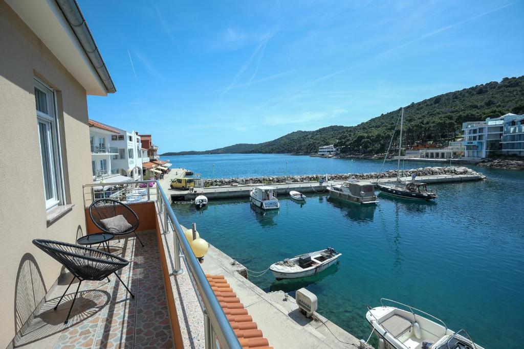 a view of a harbor with boats in the water at Exceptional Apartment Juniper, FIRST ROW TO THE SEA in Božava