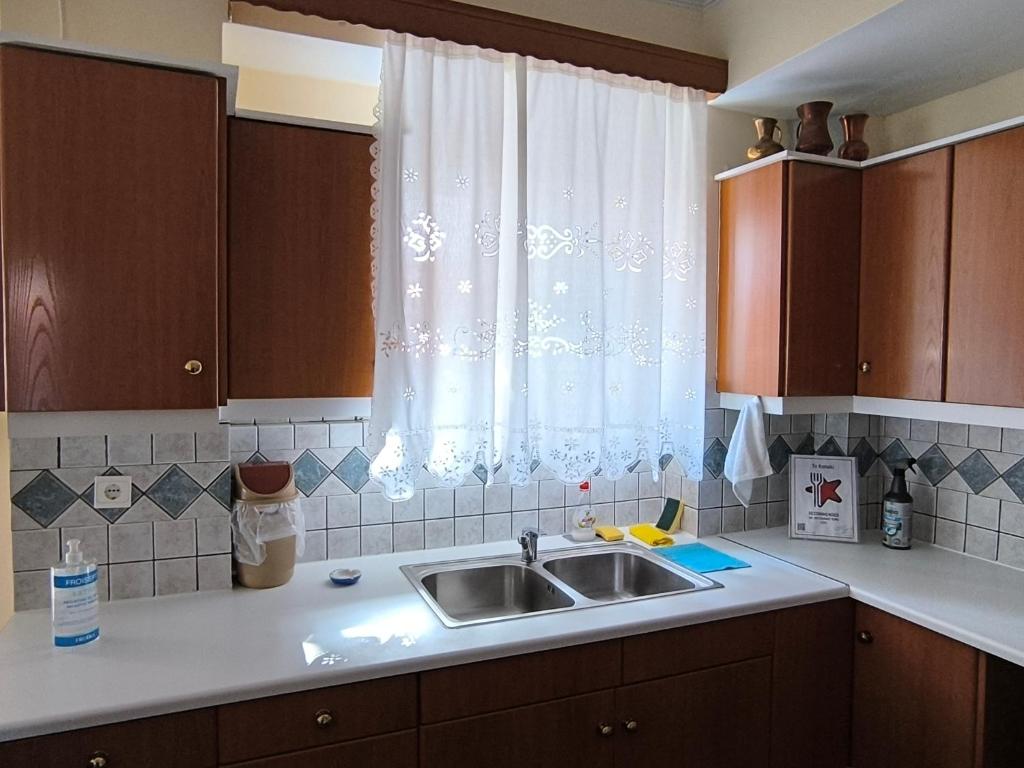 a kitchen with a sink and a window at Robert House in Samos