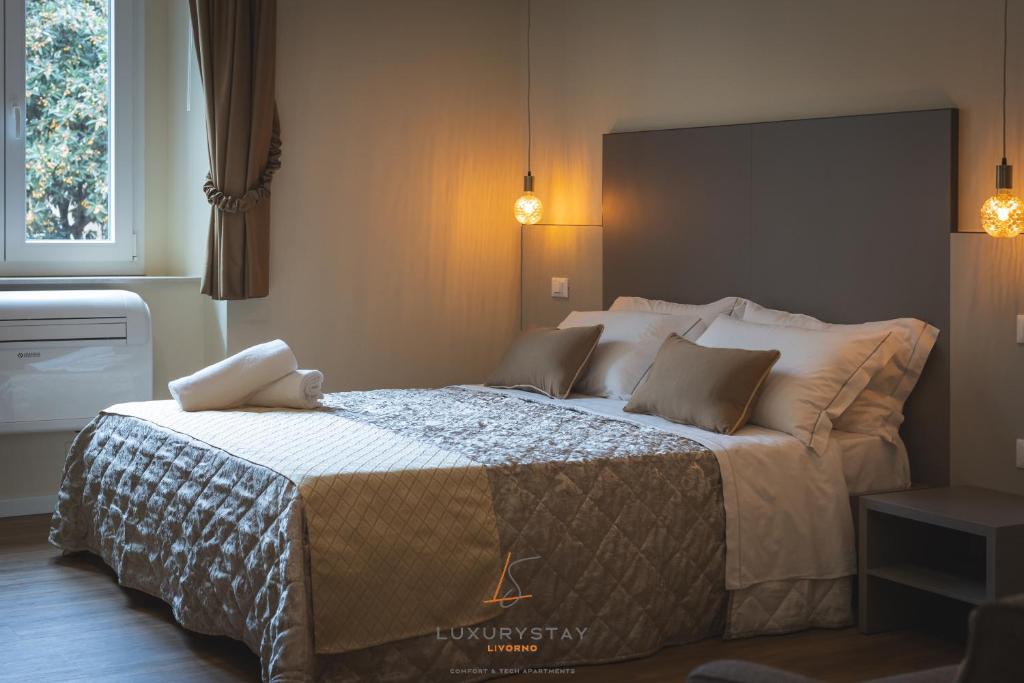 Katil atau katil-katil dalam bilik di LivornoLuxuryStay