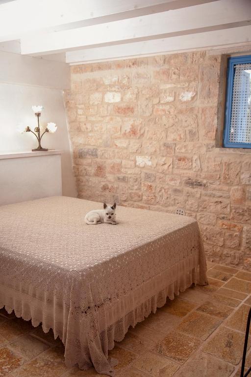 Postel nebo postele na pokoji v ubytování Trulli alla Controra