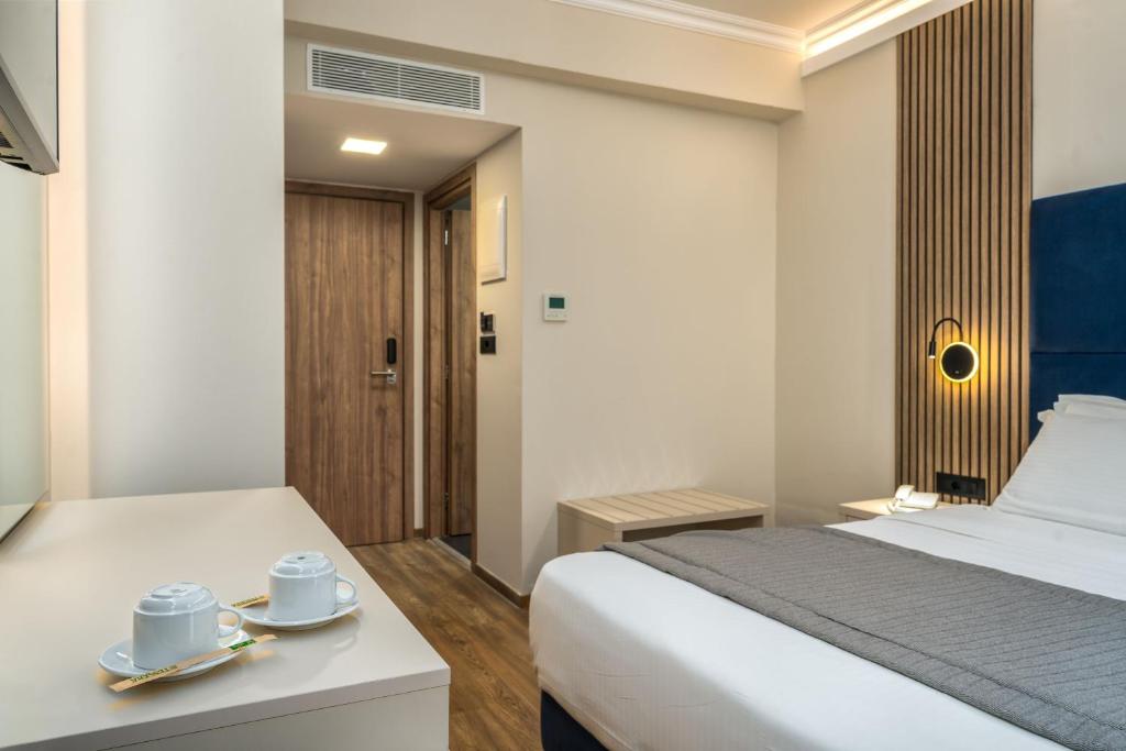 Postel nebo postele na pokoji v ubytování Palatino Hotel