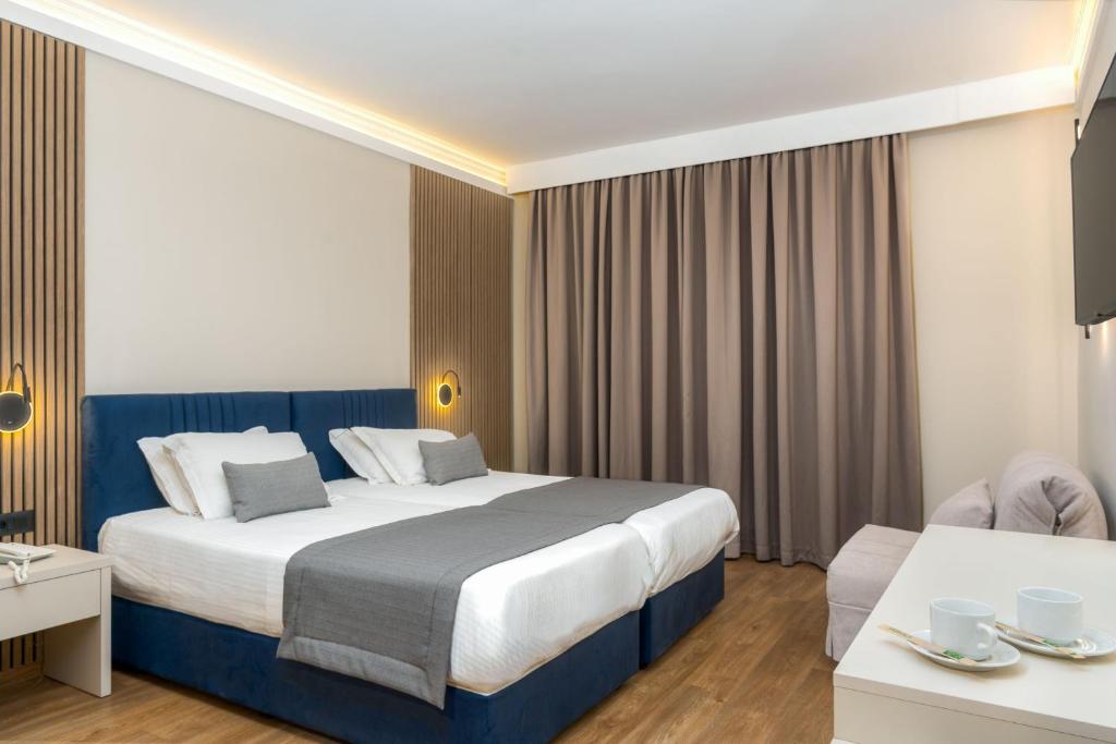 Ένα ή περισσότερα κρεβάτια σε δωμάτιο στο Ξενοδοχείο Παλατίνο 