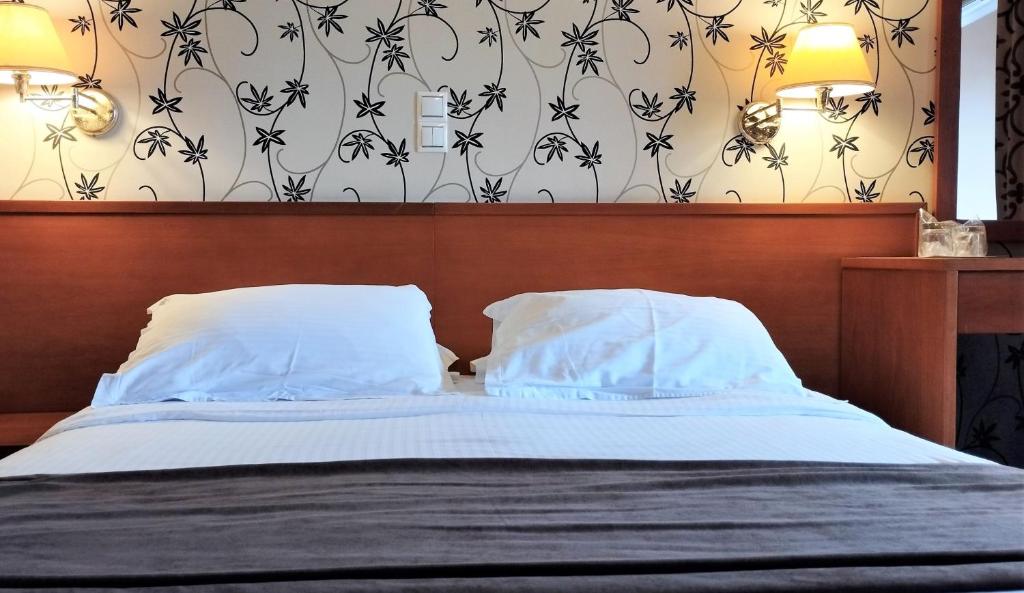 Postel nebo postele na pokoji v ubytování Palatino Hotel