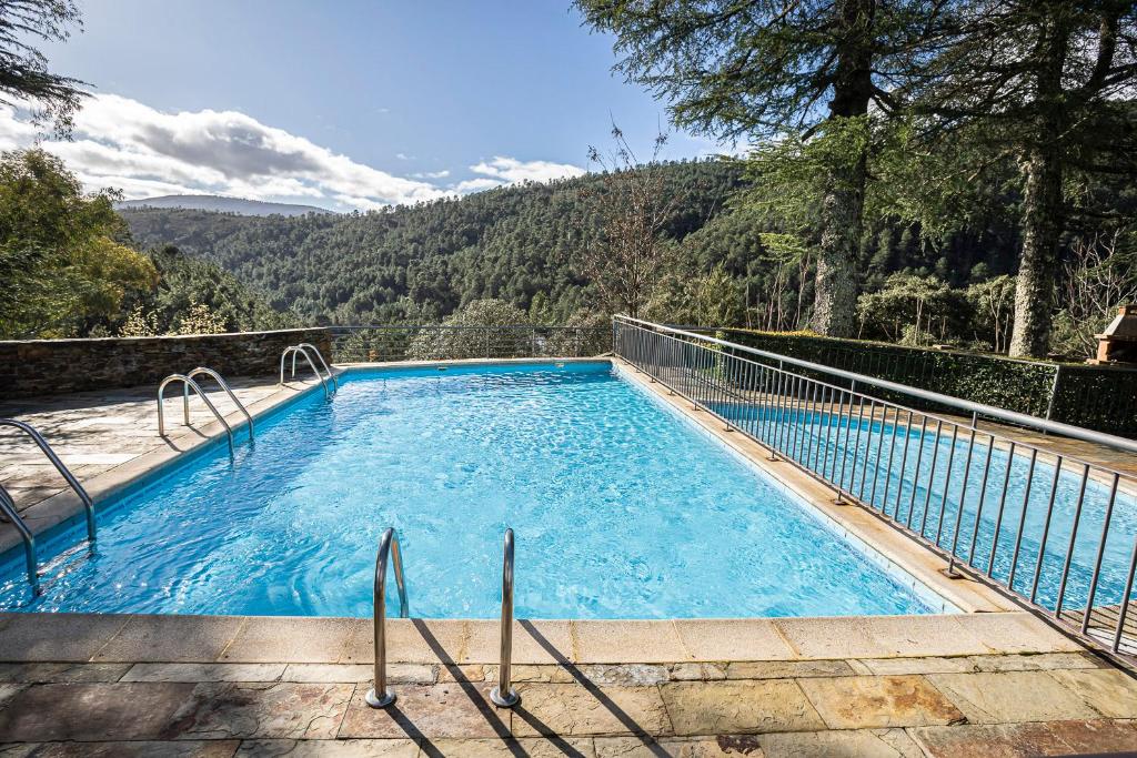 a swimming pool with a view of a mountain at Hospederia Hurdes Reales in Las Mestas
