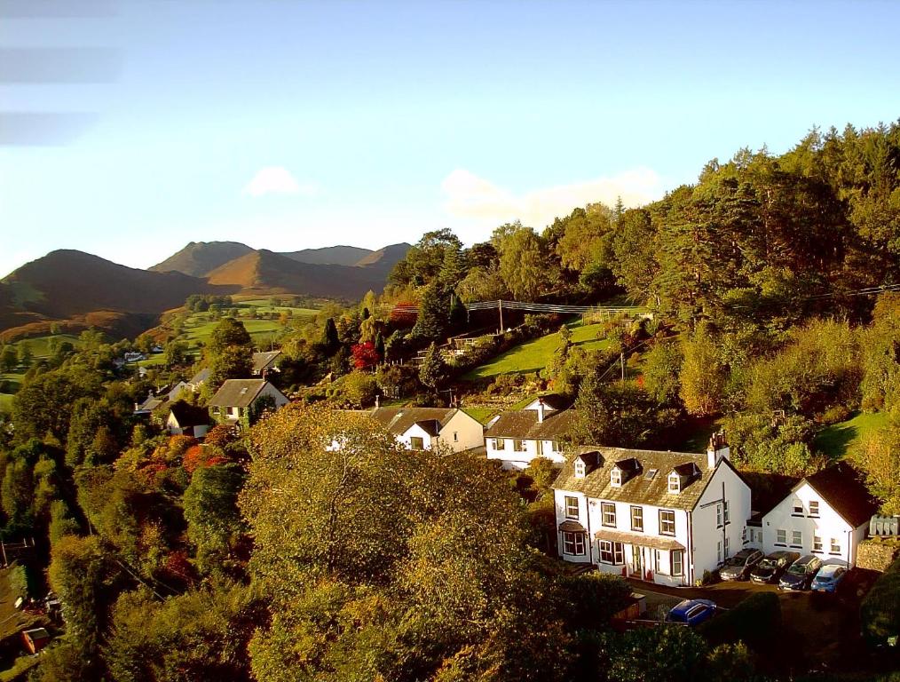 a village with houses and trees on a hill at Fern Howe Guest House in Keswick