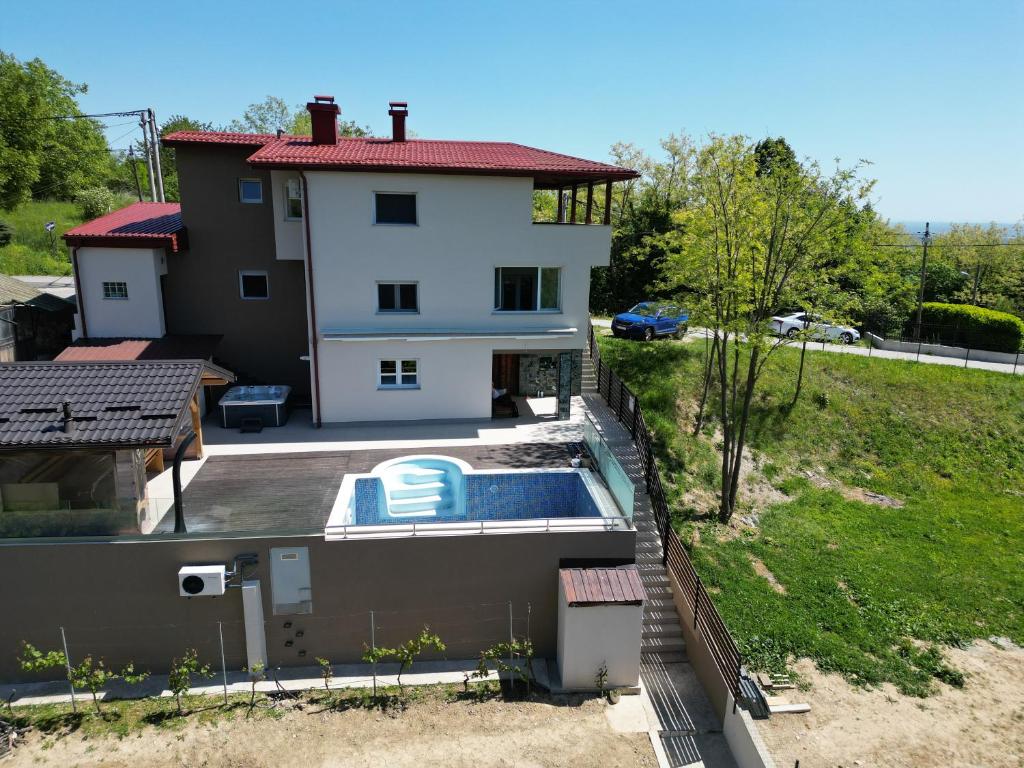 a house with a swimming pool in front of it at Čarobni pogled Zagreb in Zagreb