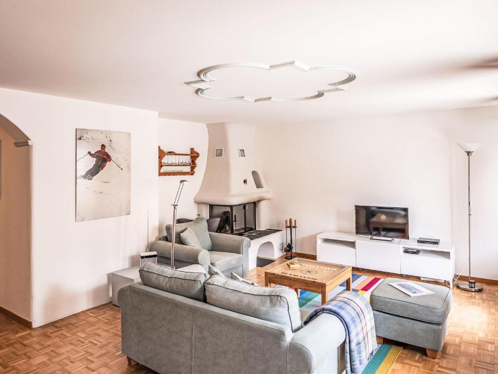 a living room with a couch and a table at Apartment Chesa Mezzaun by Interhome in Zuoz