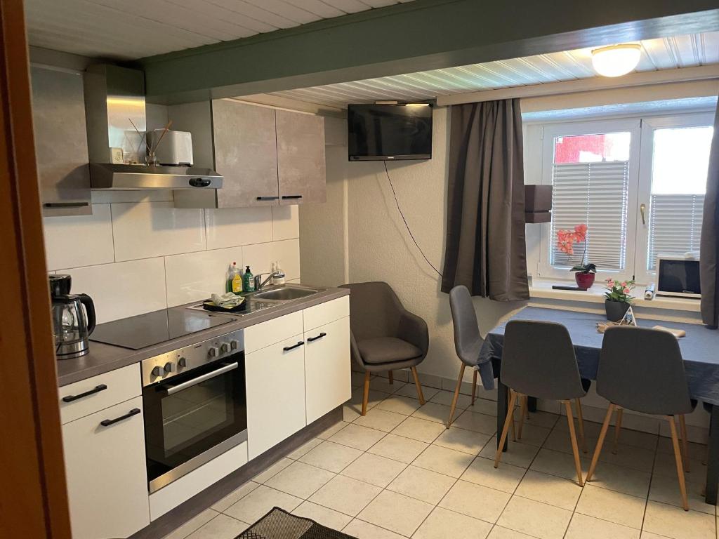 a kitchen with a table and a dining room at Wasserfall in Stall