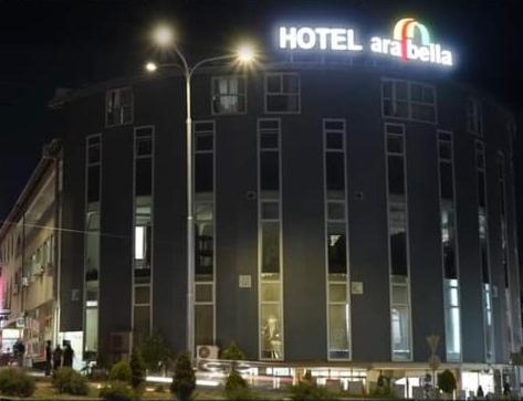 a hotel building with a sign on it at night at Arabella Hotel in Kičevo