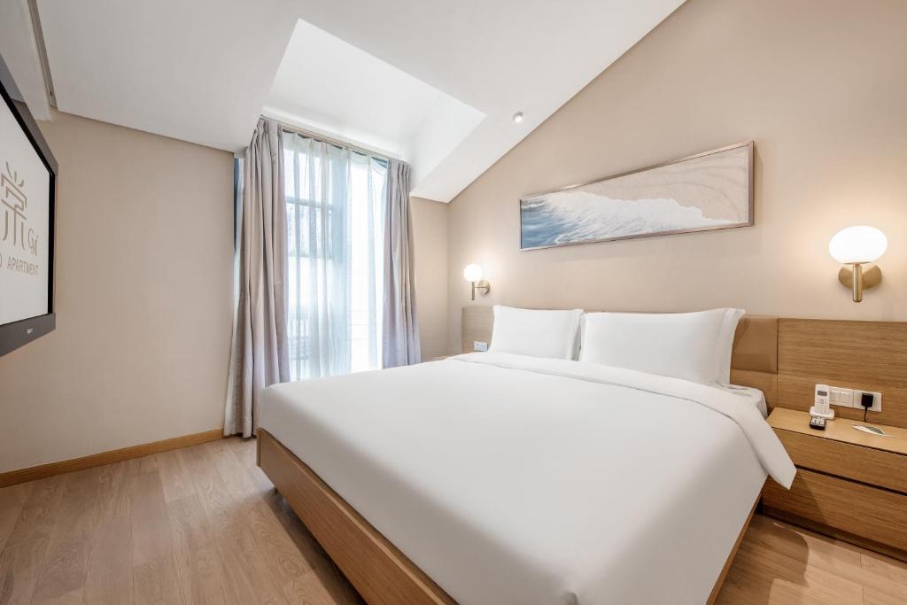 Postel nebo postele na pokoji v ubytování CM Serviced Apartment Shenzhen Hillside