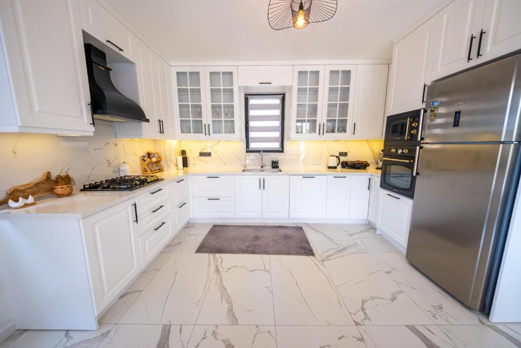 A kitchen or kitchenette at Olive Hills Villa - Family-Friendly Luxury Villa Yesiluzumlu Fethiye by Sunworld Villas