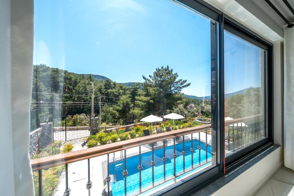 The swimming pool at or close to Olive Hills Villa - Family-Friendly Luxury Villa Yesiluzumlu Fethiye by Sunworld Villas
