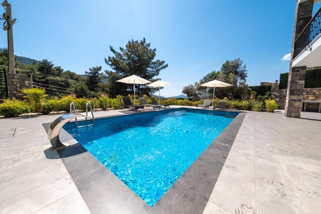 The swimming pool at or close to Olive Hills Villa - Family-Friendly Luxury Villa Yesiluzumlu Fethiye by Sunworld Villas