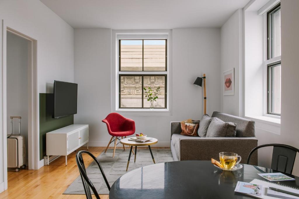 a living room with a couch and a table at Sonder Le Victoria in Montréal