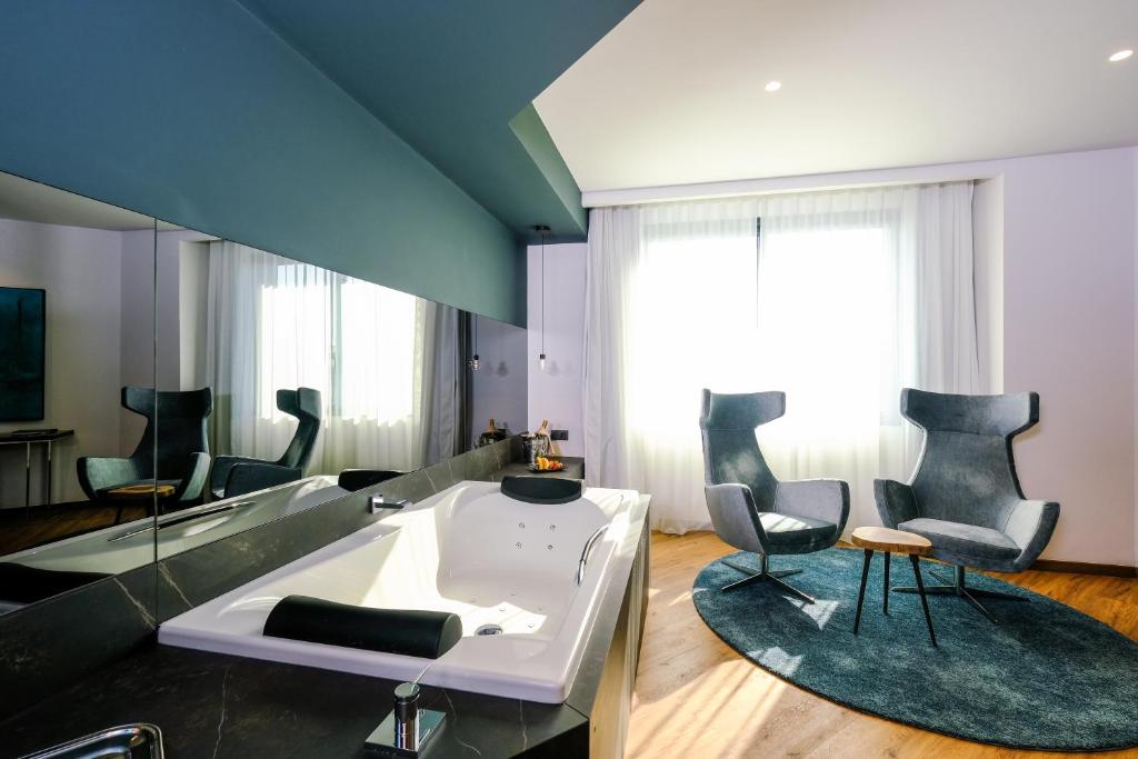a living room with chairs and a table at Hotel SB Icaria in Barcelona