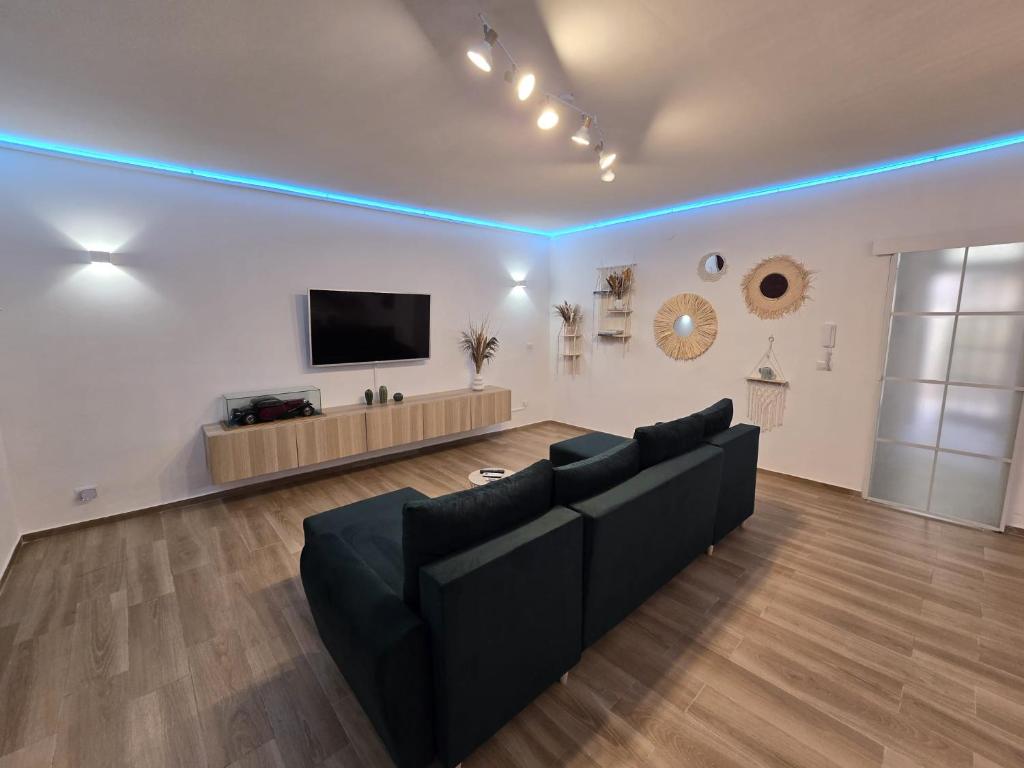 a living room with a couch and a flat screen tv at Sea and Sand's Ville HOWME in Bari