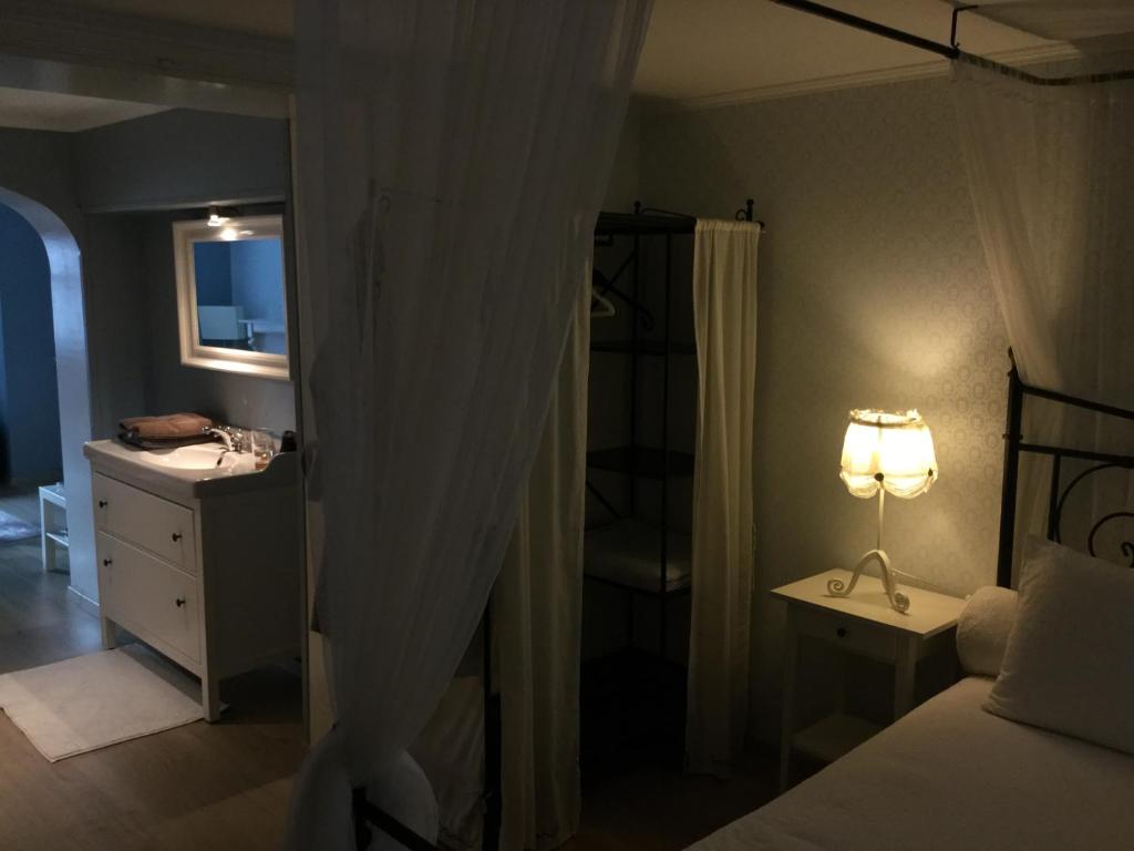 a bedroom with a bed and a desk with a lamp at B&B Wellness Yoake in Ypres