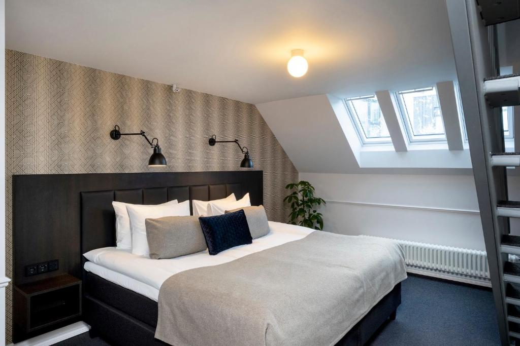 Postel nebo postele na pokoji v ubytování Hotel Reykjavík Saga