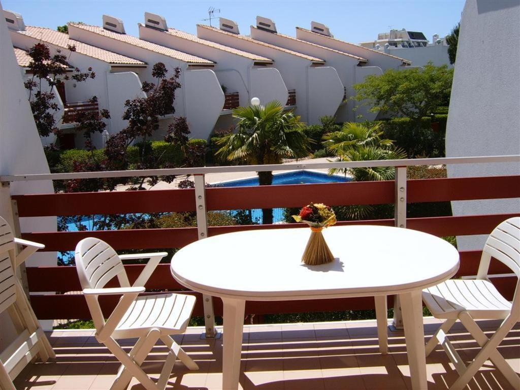 a white table and chairs on a balcony at Résidence Green Village in La Grande Motte