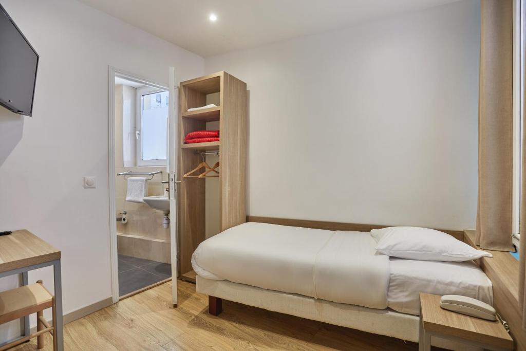 Postel nebo postele na pokoji v ubytování Merryl Hotel