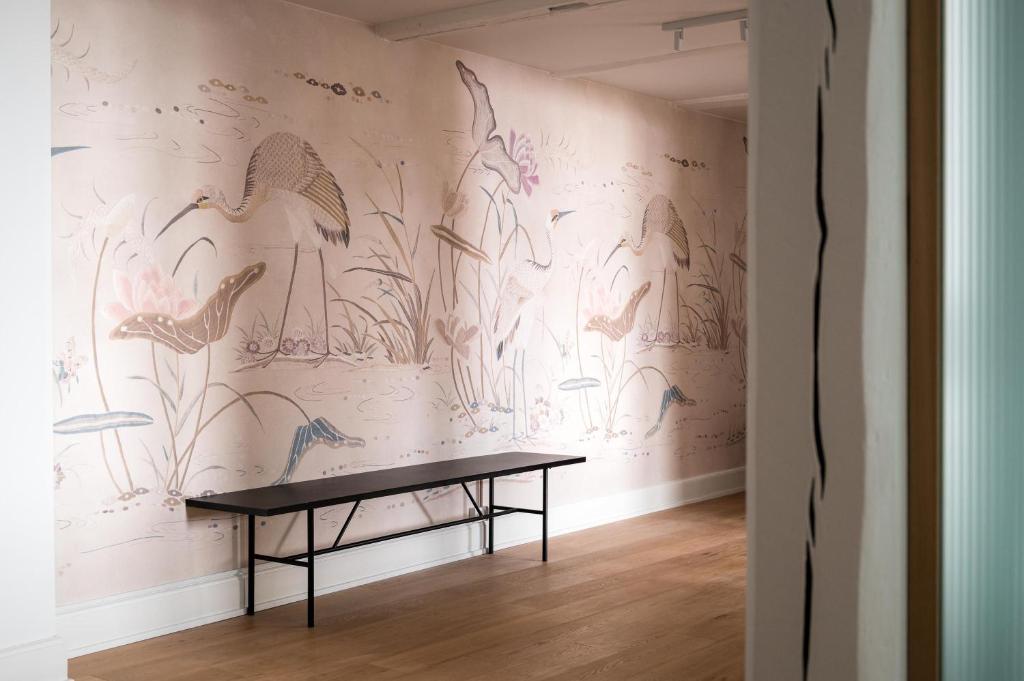 a wall with a mural of birds on it at Kings Square apartments by Daniel&Jacob's in Copenhagen
