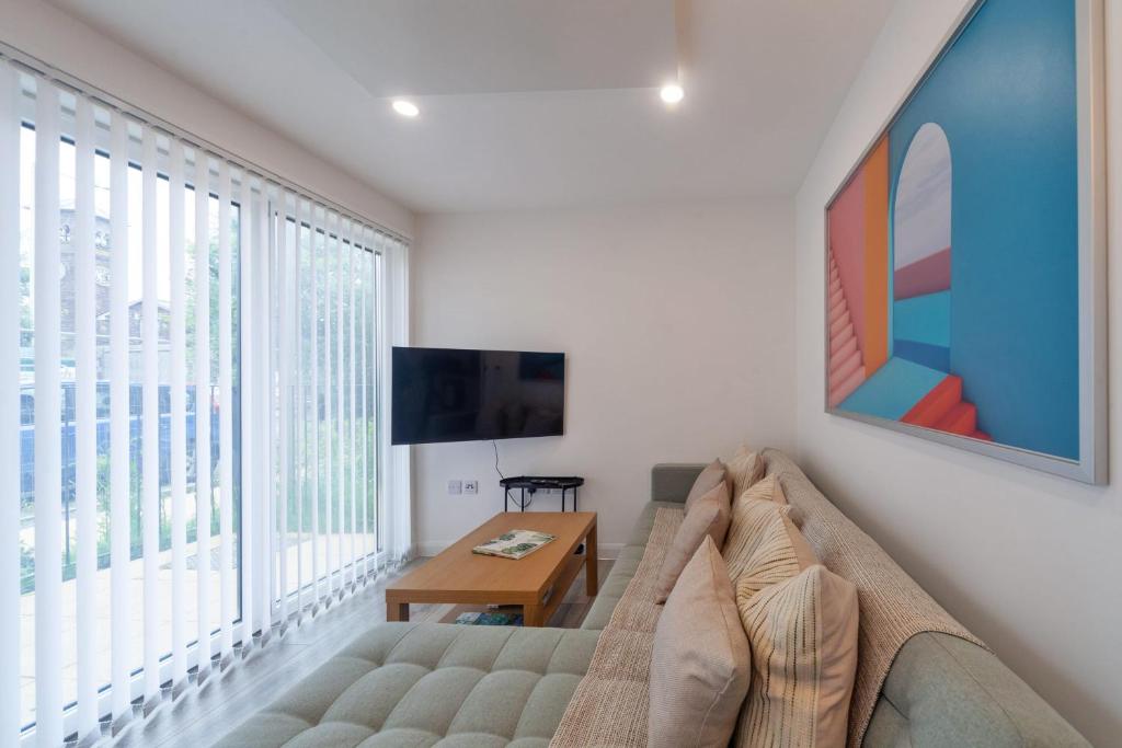 a living room with a couch and a large window at Fantastic 2 Bedroom Apartment in Ashford in Ashford
