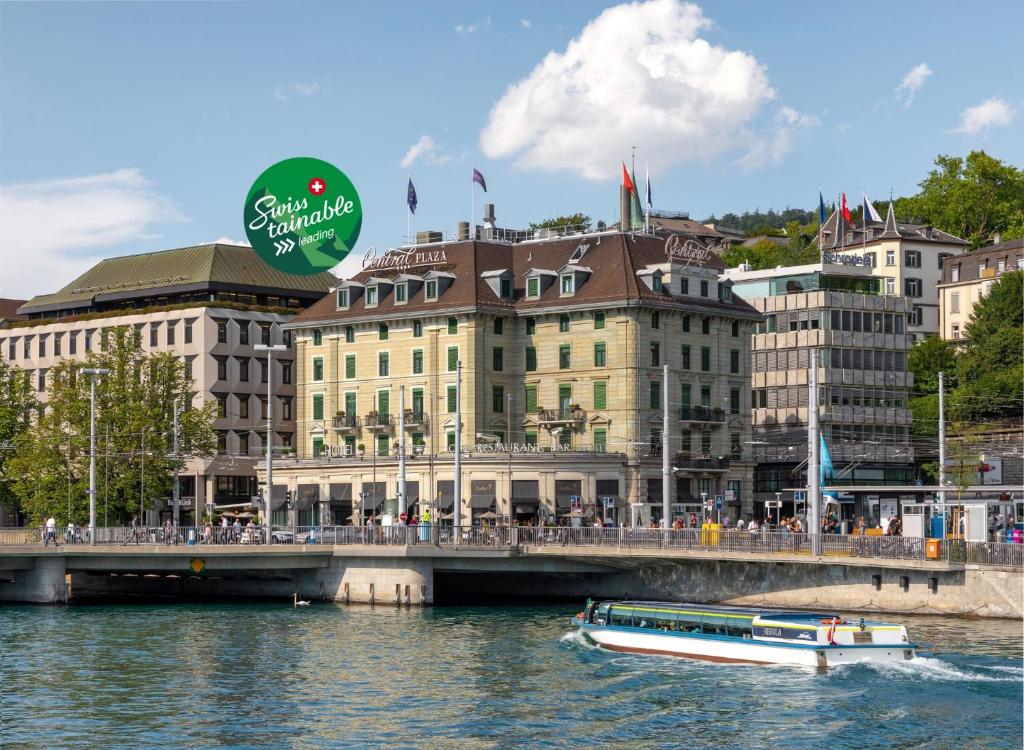 a boat on the river in front of buildings at Central Plaza in Zürich