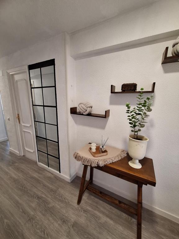 a room with a table with a potted plant on it at Beautiful 2 Bedrooms Aparatament in Benidorm