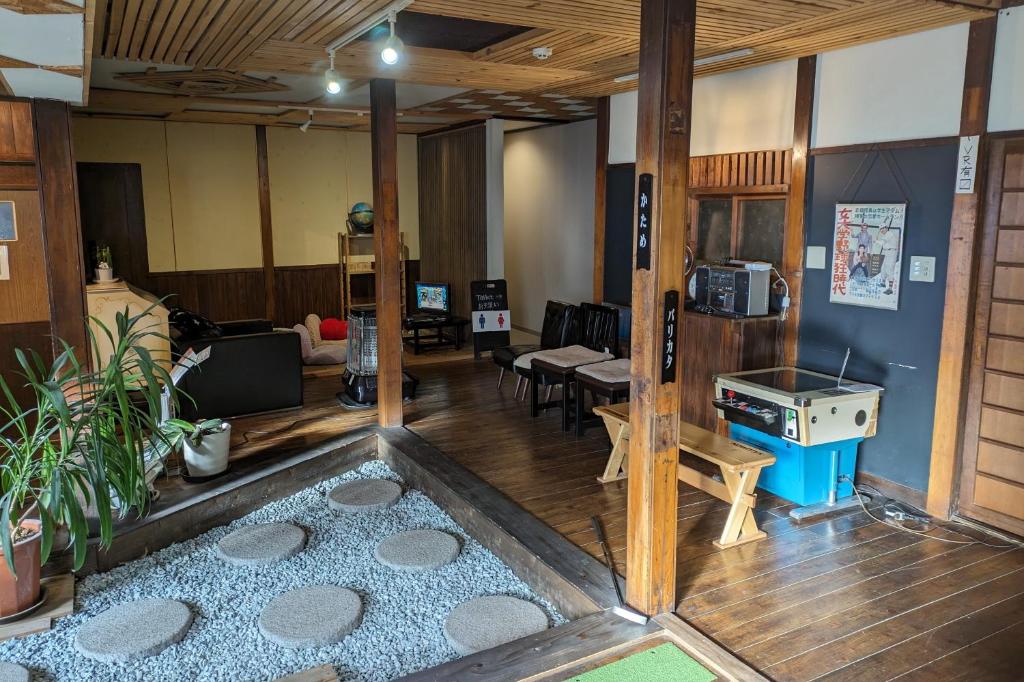 a living room with a room with a stove in it at Kusatsu Onsen Eidaya in Kusatsu