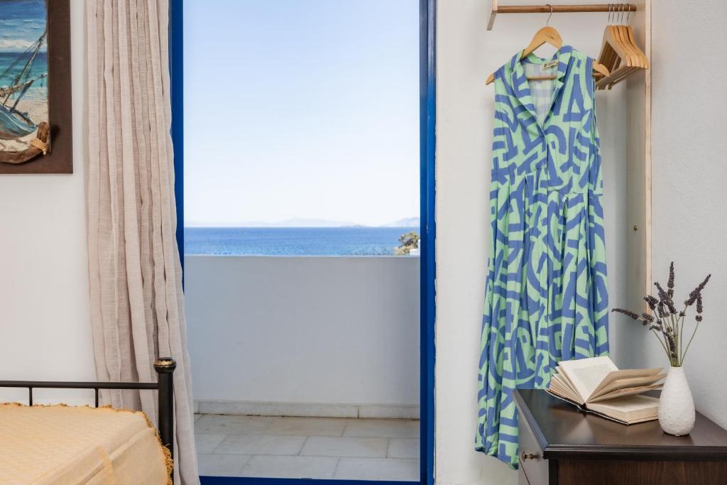 a bedroom with a blue and white shower curtain at Hippocampus studios 2 min walk from the beach in Moutsoúna