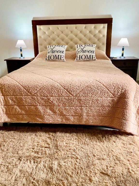 a bedroom with a large bed with two pillows at Loano I - Confort Moderno en Primer Piso con acceso por escalera! in Belén de Escobar