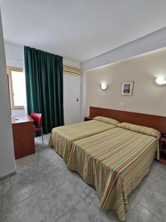 Postel nebo postele na pokoji v ubytování Hotel Camposol