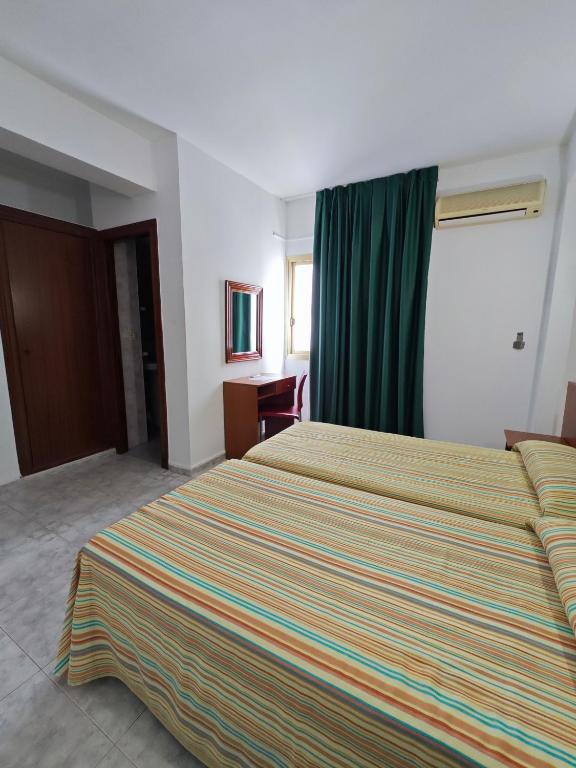 Postel nebo postele na pokoji v ubytování Hotel Camposol