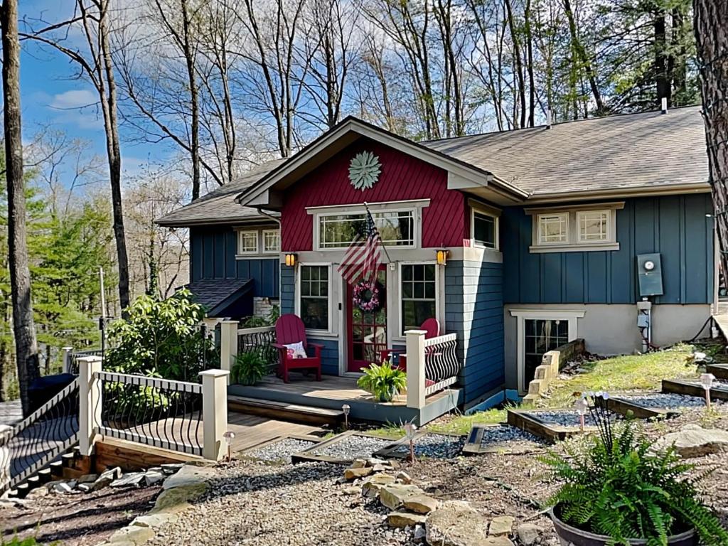 a blue and red house with a porch at Acorn Cottage in Oakland