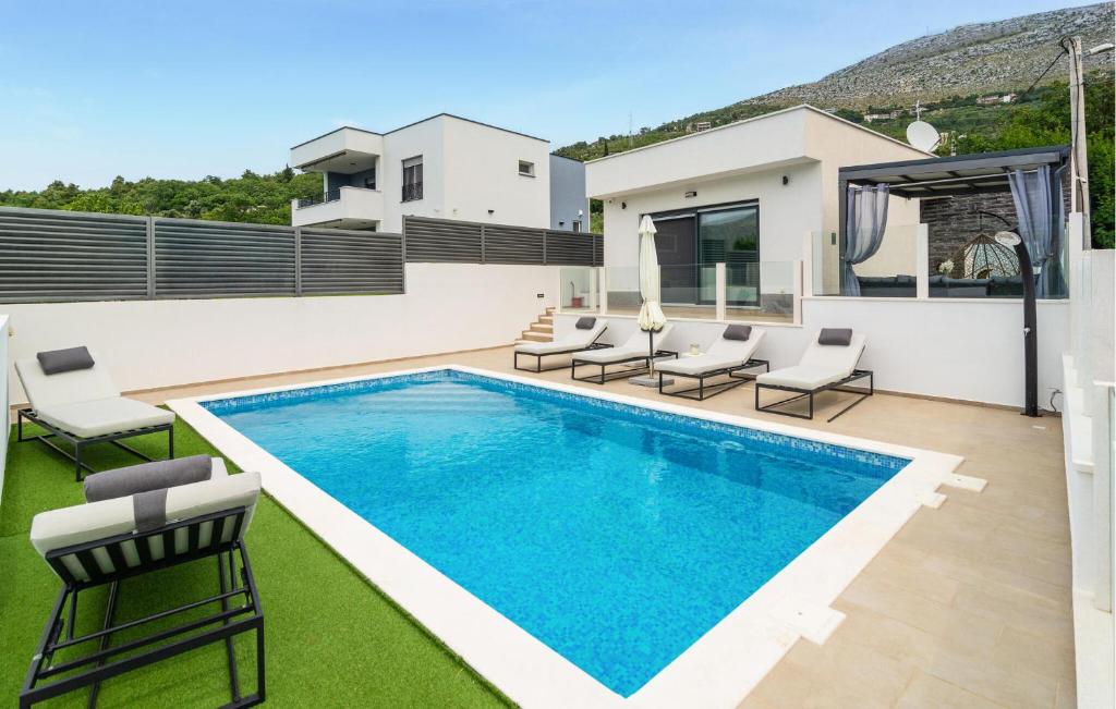 a swimming pool on the roof of a house at Lovely Home In Srinjine in Srinjine
