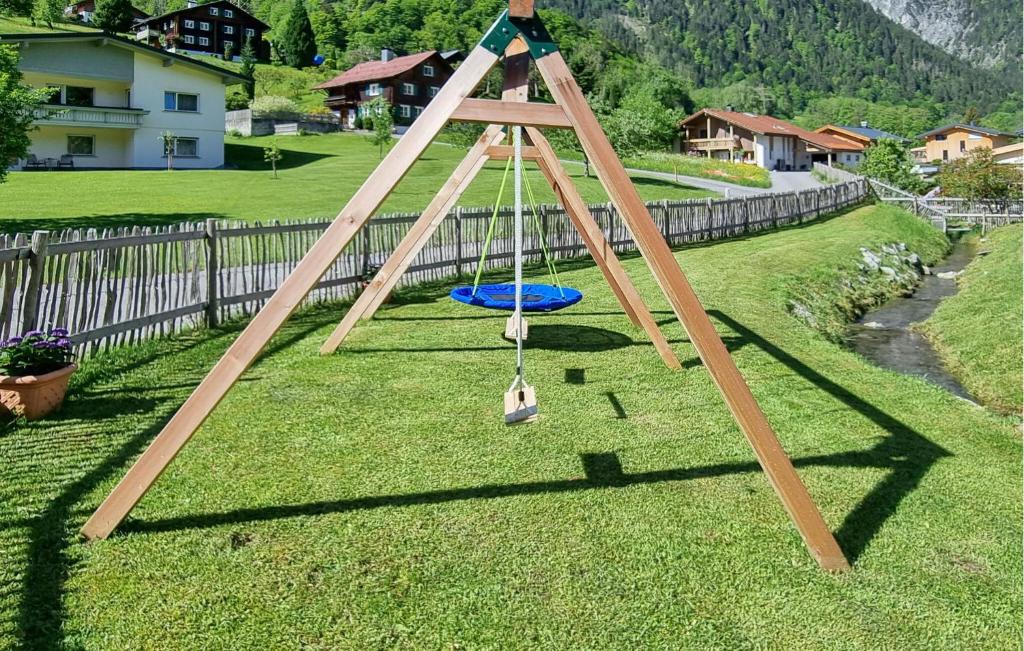 a wooden swing set on the grass in a yard at Lovely Home In Dalaas With Kitchen in Dalaas