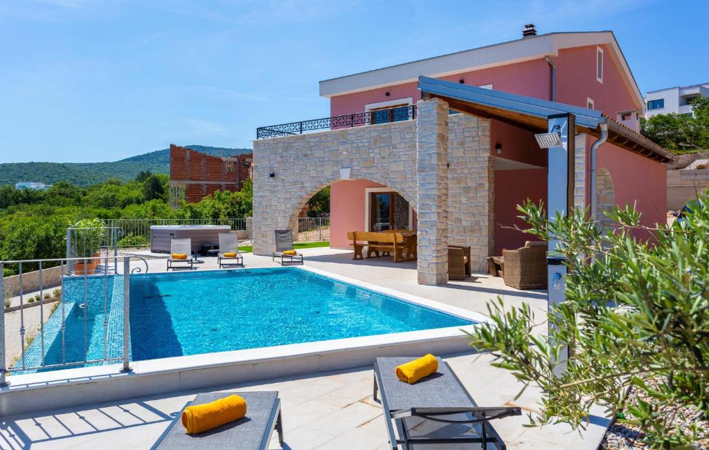 a villa with a swimming pool and a house at Pet Friendly Home In Vrbnik With Wifi in Vrbnik