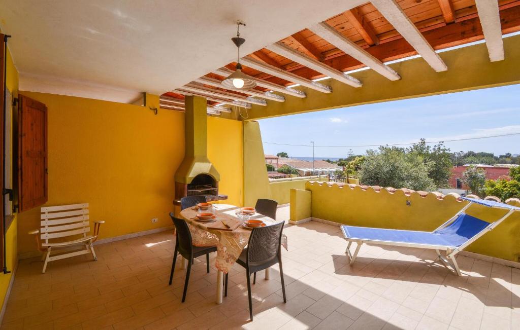 a patio with a table and chairs and a fireplace at Secca in Costa Rei