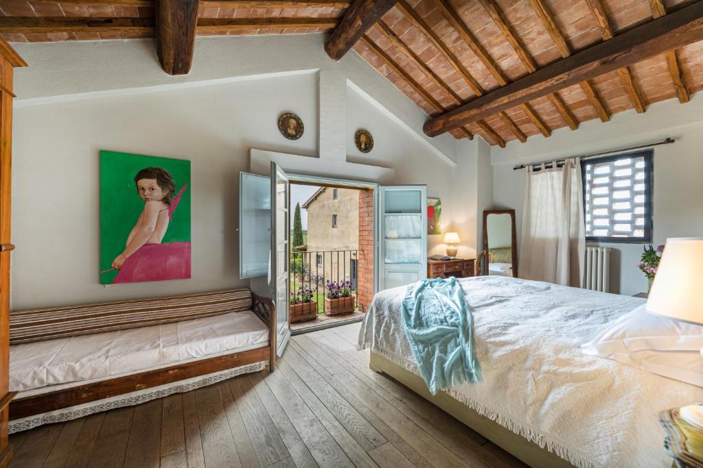 a bedroom with a large bed and a window at Casa vacanze Aurora in Isola d'Arbia
