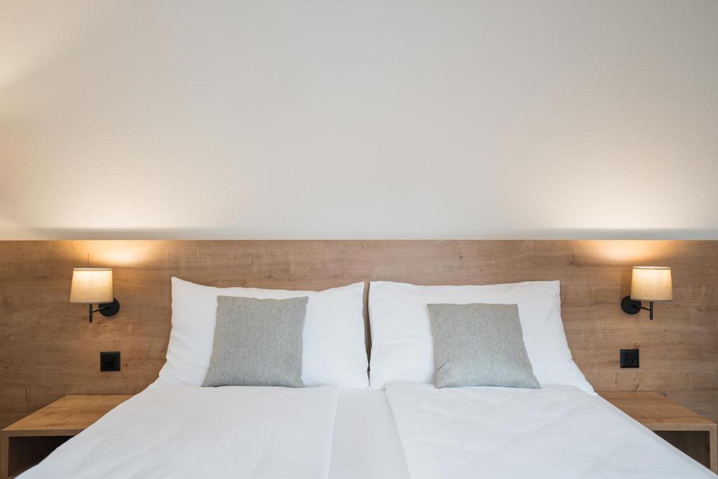Postel nebo postele na pokoji v ubytování Hotel Brocco & Posta