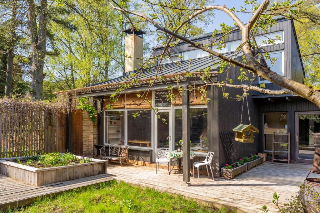a home with a deck and a patio at Family private house in Dubulti, Jurmala, 400m to the beach in Jūrmala
