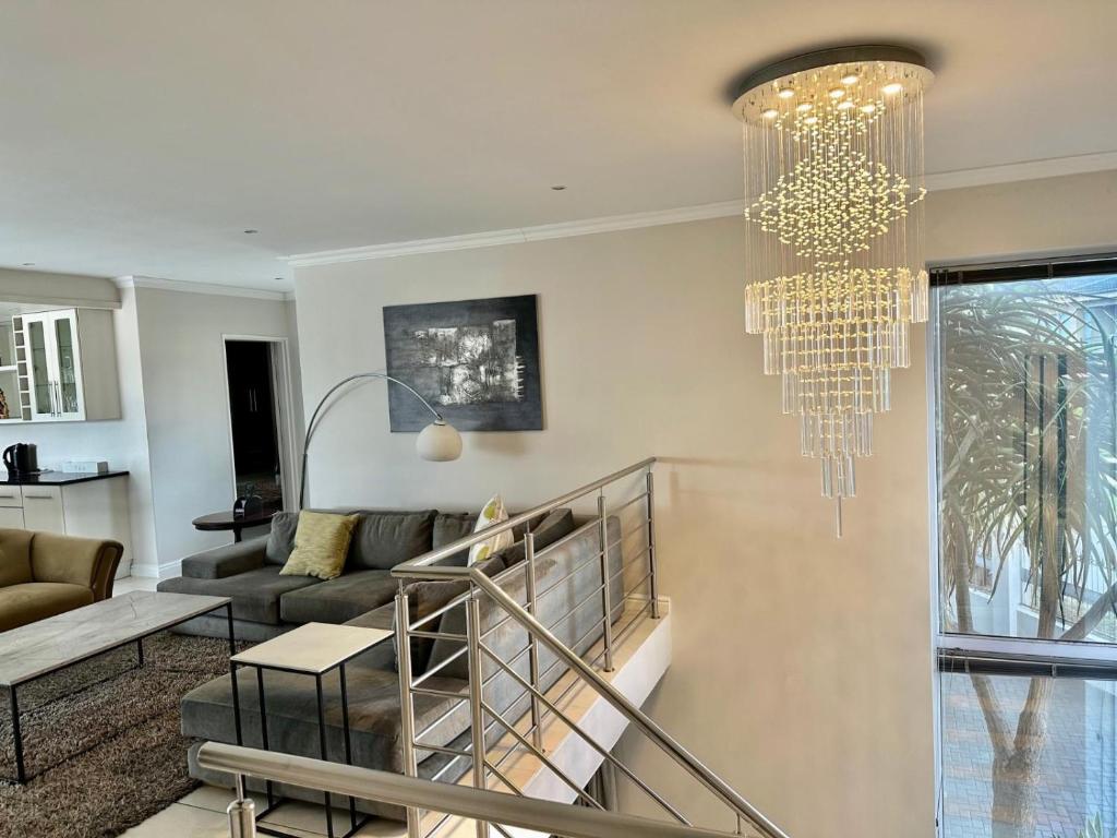 a living room with a chandelier at Amani Luxe Villa in Amsterdamhoek