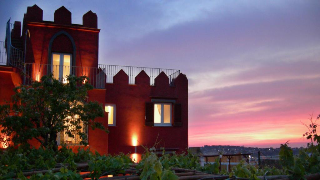 a building with a sunset in the background at Albergo 'La Vigna' in Procida