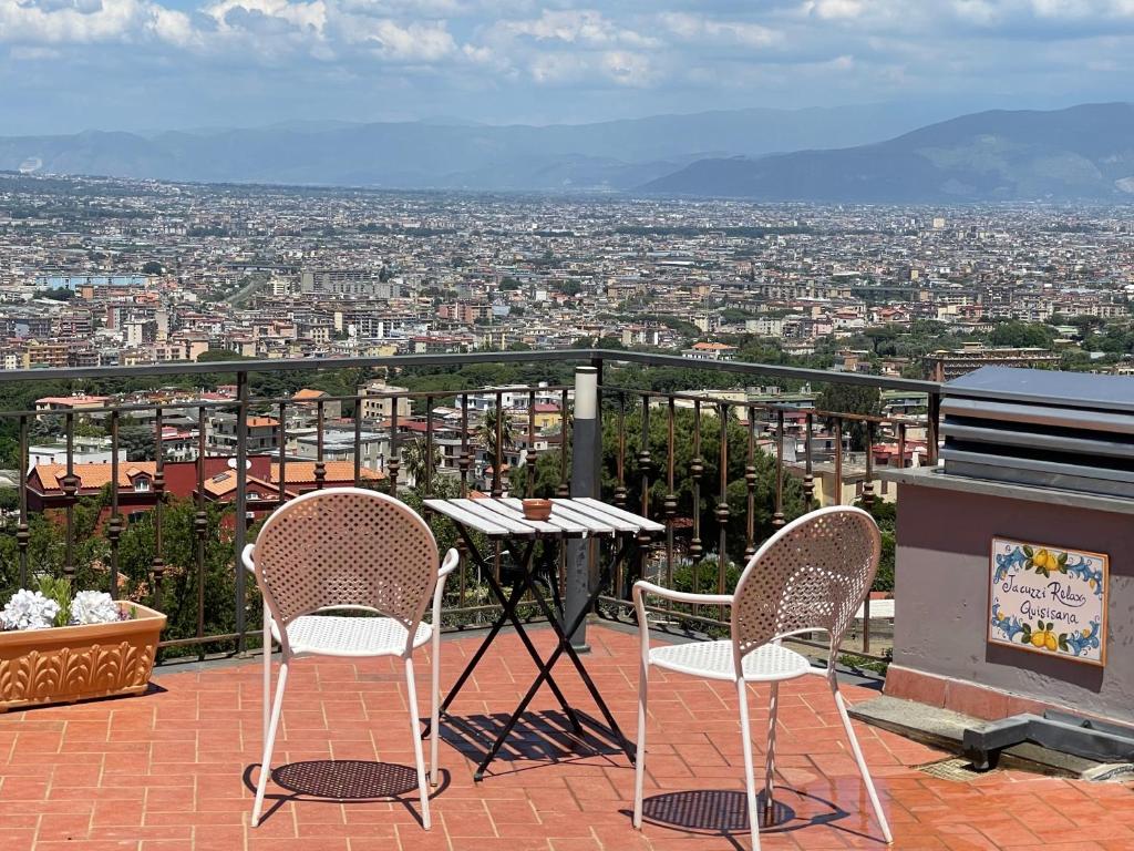 two chairs and a table on a balcony with a view at La Terrazza Quisisana Sorrento Coast in Castellammare di Stabia