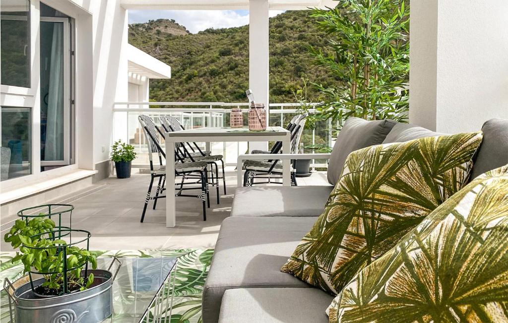 a living room with a couch and a table on a balcony at Benahavis Village in Benahavís