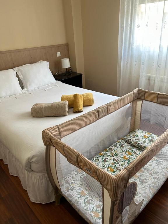 a bed with two pillows and a chair in a bedroom at Villa María in El Astillero